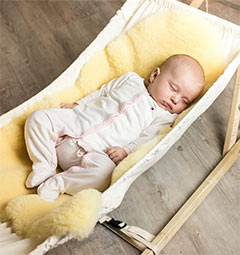 Baby in a pram on a medical sheepskin